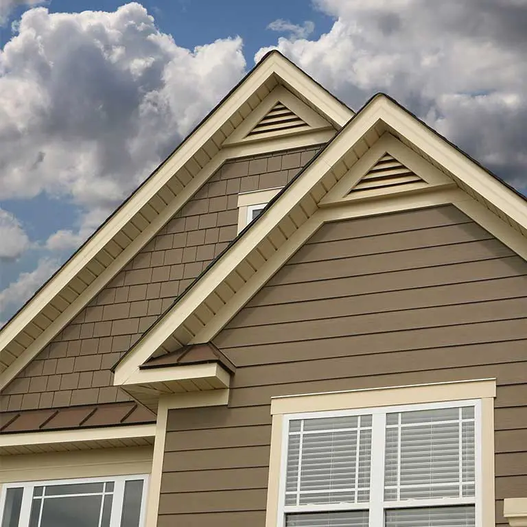 Brown siding on top section of the front of a house