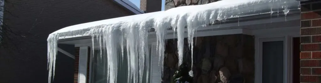 Ice dam damage to a roof in winter