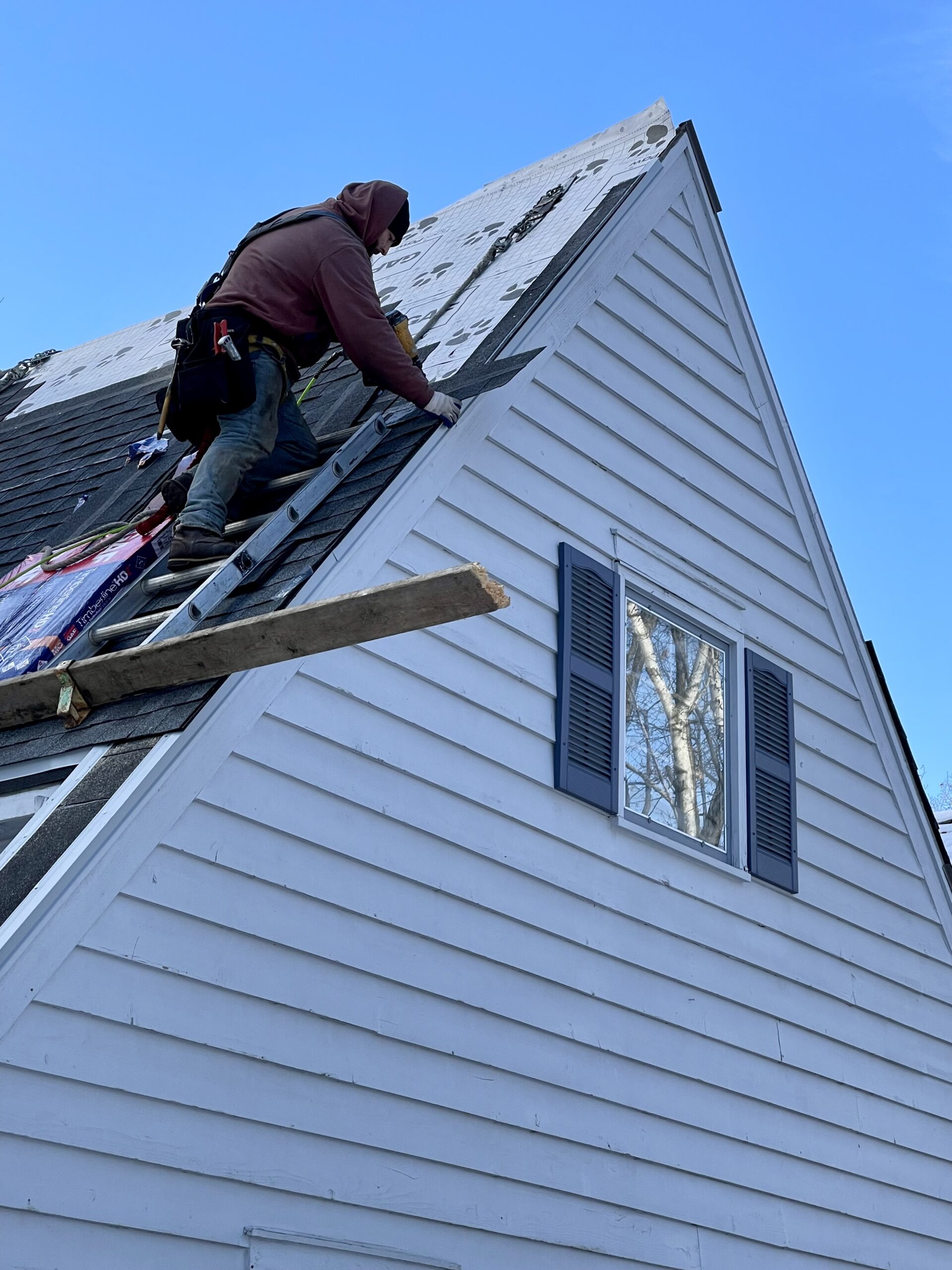 L.H. Krueger and Son employee working on re-roofing a home in Delafield, WI