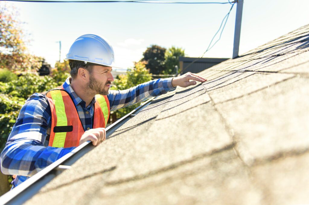 insurance field adjuster inspecting roof for hail damage