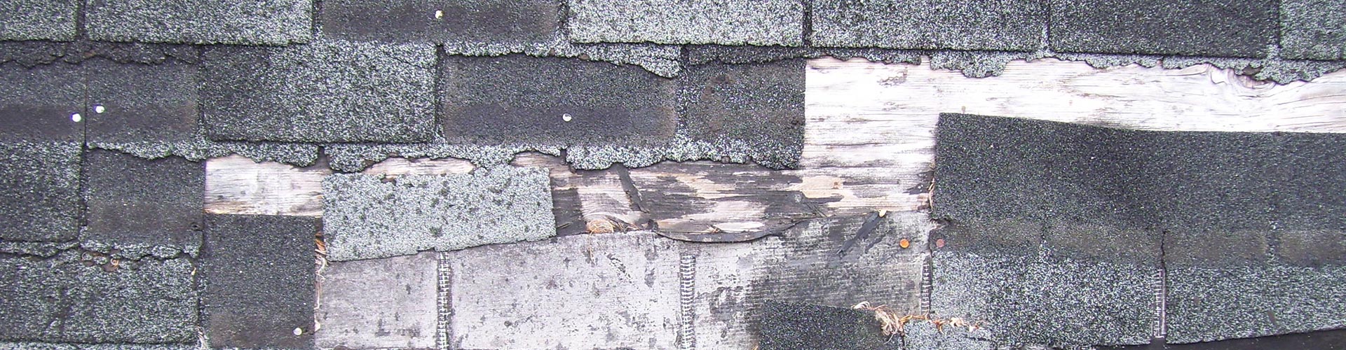 Roofing shingles in missing and in poor condition prior to roof replacement
